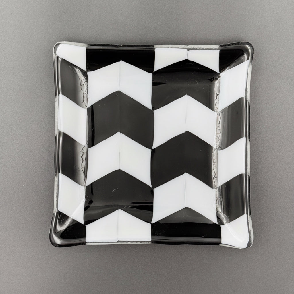 Black and white zigzag patterned ceramic dish on a gray background