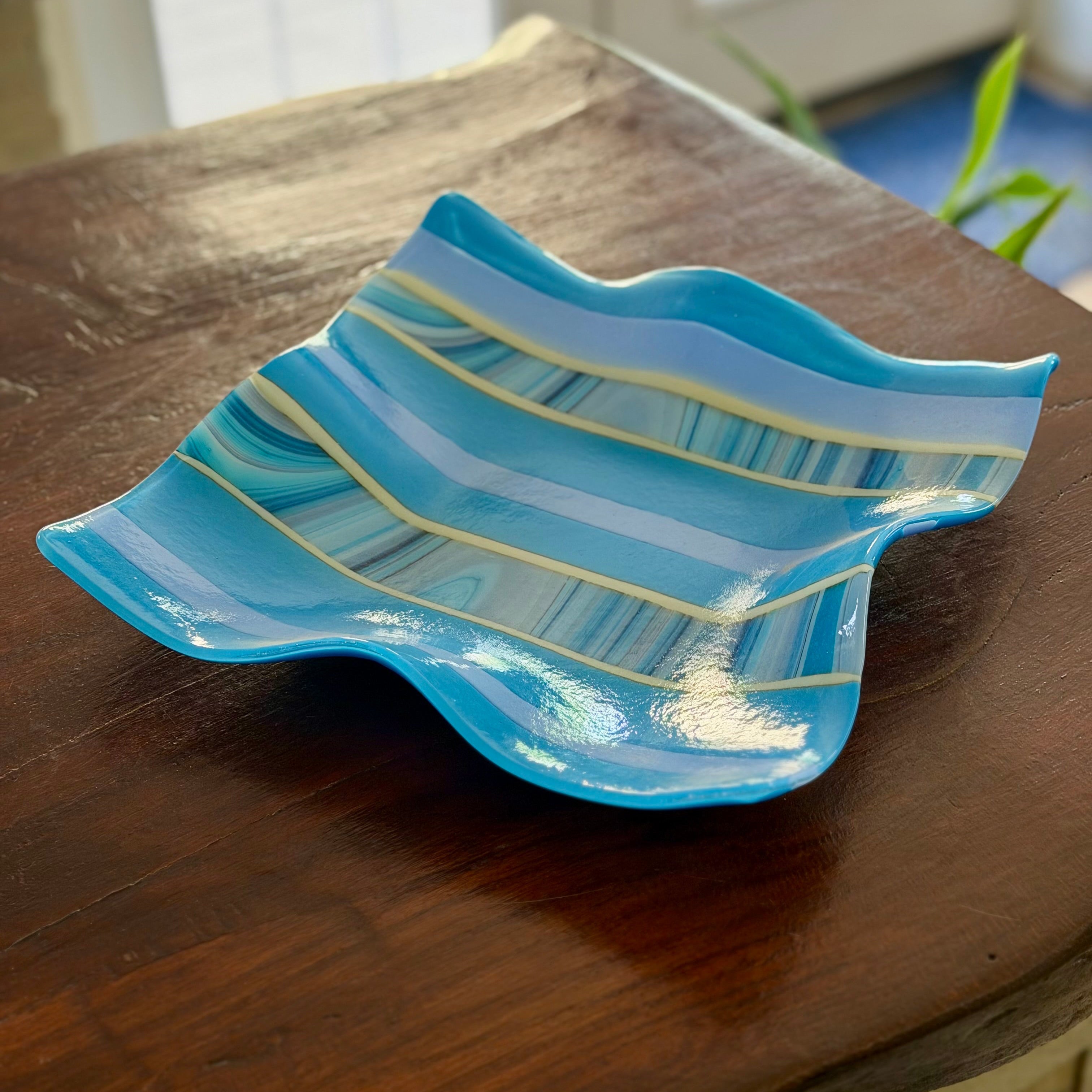 Square Blue wavy glass bowl on brown background 