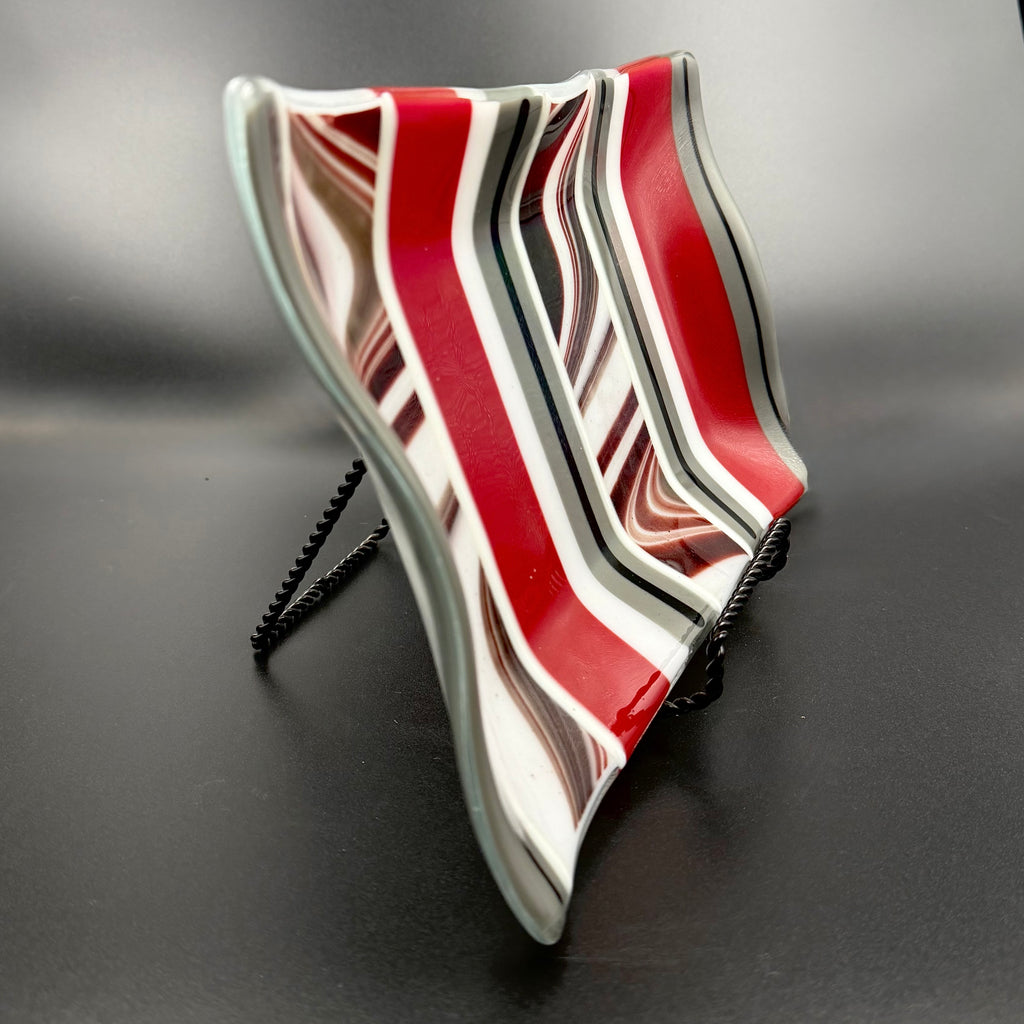 Marbled red, white, and black shoe on a gray background